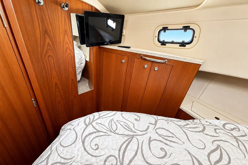 Slide: The Image of 2001 Mainship 390 Trawler cabin interior with wood cabinetry and mounted TV. - 24
