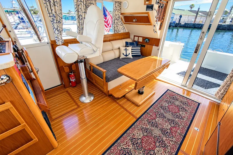 Slide: The Image of Interior of 2001 Mainship 390 Trawler with wooden flooring and nautical decor. - 16