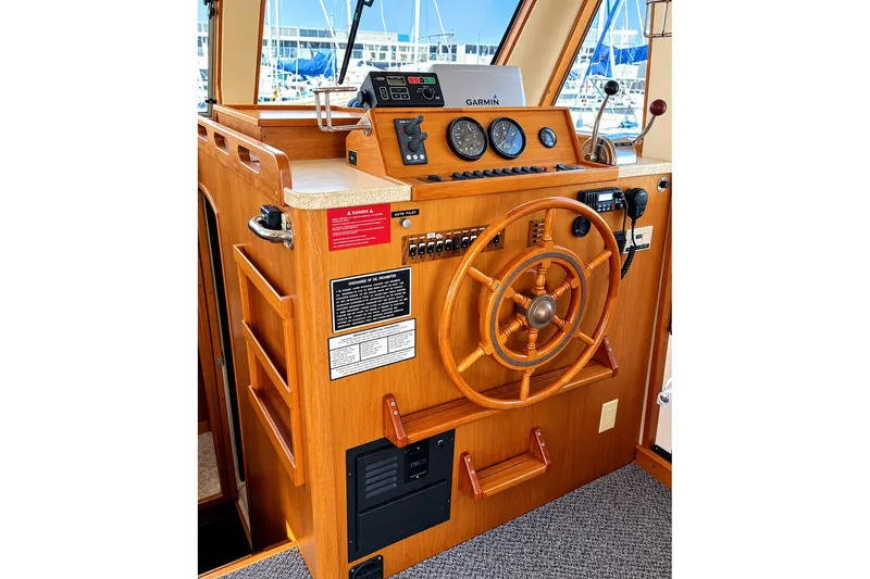 Slide: The Image of 2001 Mainship 390 Trawler helm with wooden wheel and navigation instruments. - 14