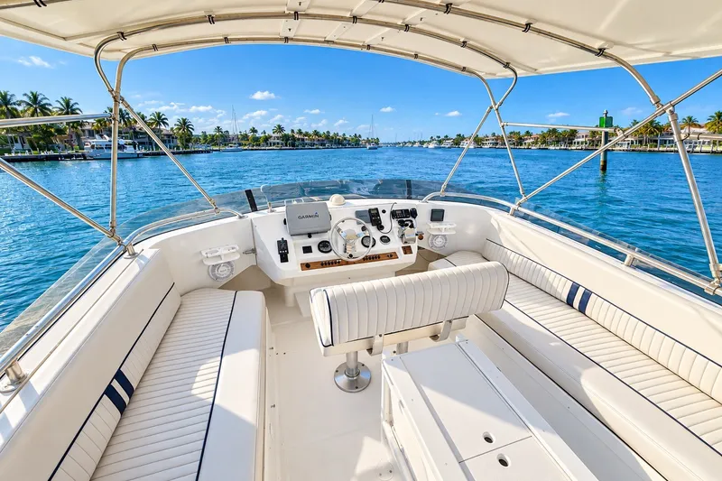 Slide: The Image of 2001 Mainship 390 Trawler helm with scenic waterway view, featuring Garmin navigation system. - 31
