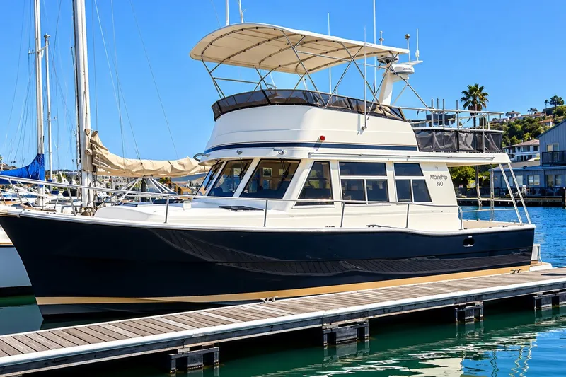 Slide: The Image of 2001 Mainship 390 Trawler docked at marina under clear blue sky. - 5