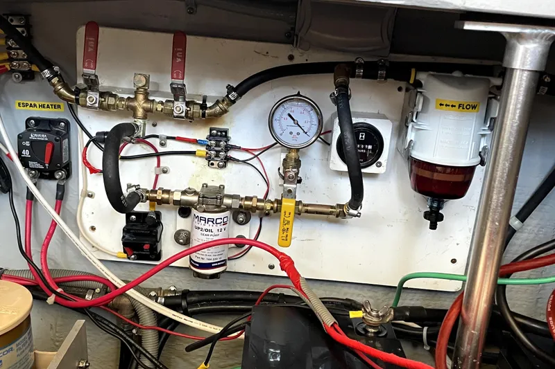 Slide: The Image of Engine room of 2001 Mainship 390 Trawler with gauges, valves, and wiring. - 33