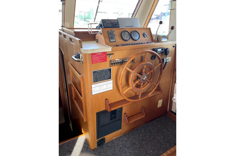 Slide: The Image of 2001 Mainship 390 Trawler helm with wooden wheel and navigation instruments. - 10