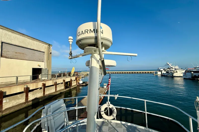 Slide: The Image of 2001 Mainship 390 Trawler docked at marina with clear blue sky. - 29