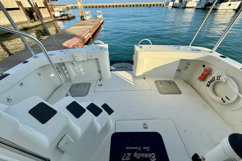 Slide: The Image of 2001 Mainship 390 Trawler boat deck at marina, featuring steps and safety equipment. - 25