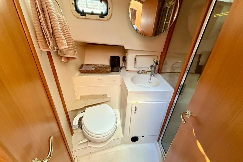 Slide: The Image of Bathroom interior of 2001 Mainship 390 Trawler with sink, toilet, and mirror. - 18