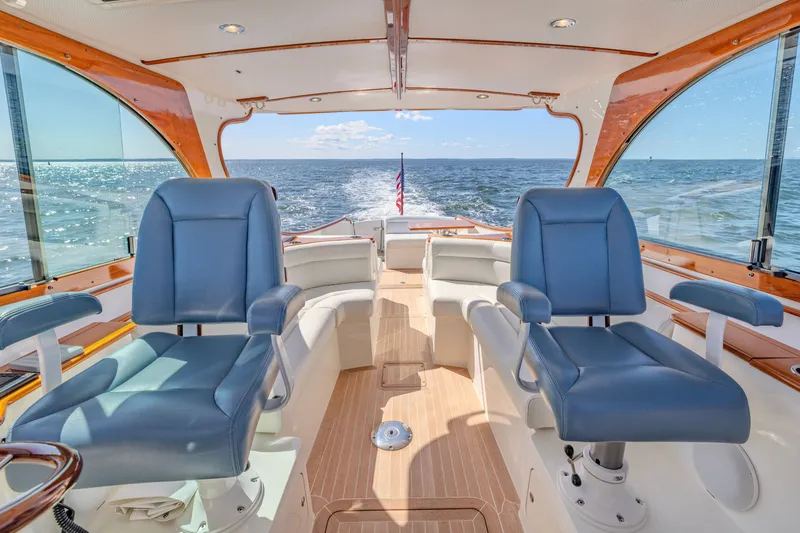 Slide: The Image of Interior of 2021 Hinckley Picnic Boat 34 MKII with blue seats and ocean view. - 9