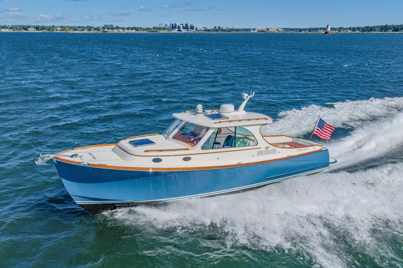 Slide: The Image of 2021 Hinckley Picnic Boat 34 MKII cruising on open water with American flag. - 6