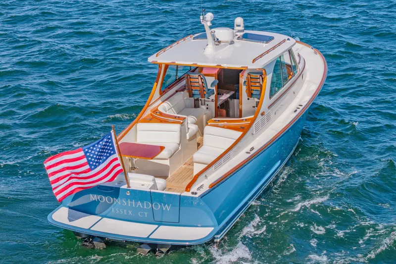 Slide: The Image of 2021 Hinckley Picnic Boat 34 MKII cruising with American flag on blue ocean. - 1