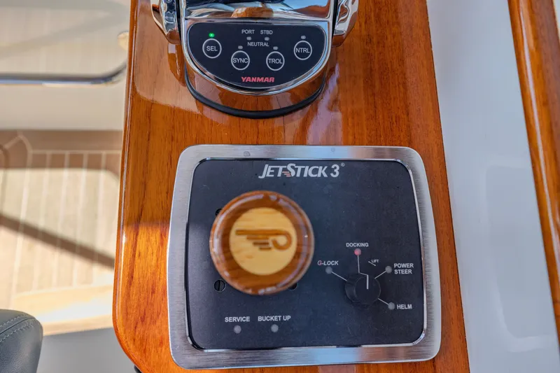 Slide: The Image of Hinckley Picnic Boat 34 MKII 2021 JetStick 3 control panel on wooden dashboard. - 13
