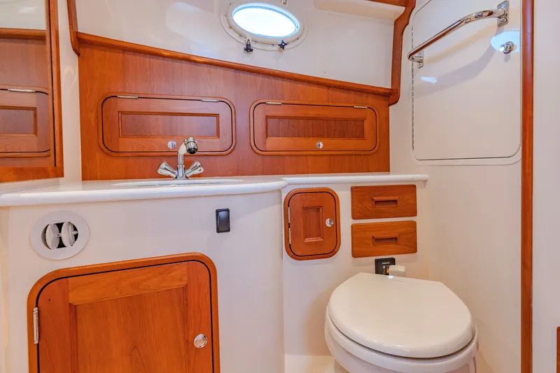 Slide: The Image of Luxurious 2021 Hinckley Picnic Boat 34 MKII bathroom with wooden cabinetry and modern fixtures. - 19