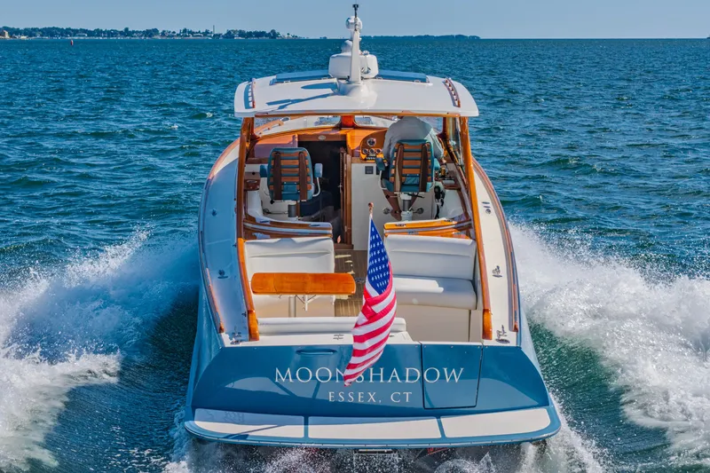 Slide: The Image of 2021 Hinckley Picnic Boat 34 MKII cruising on open water, rear view. - 21