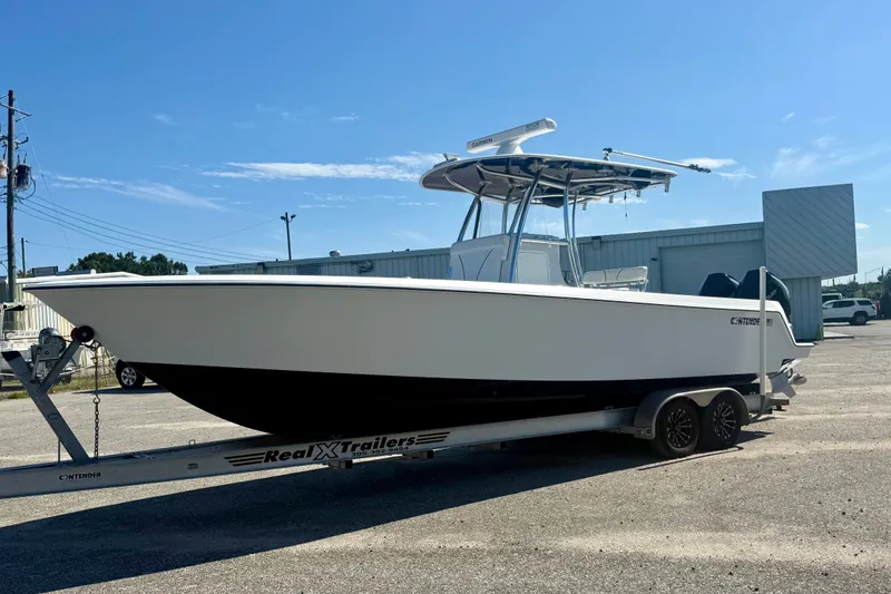 The Image of 2020 Contender 30 Tournament boat on trailer under clear blue sky. - 0