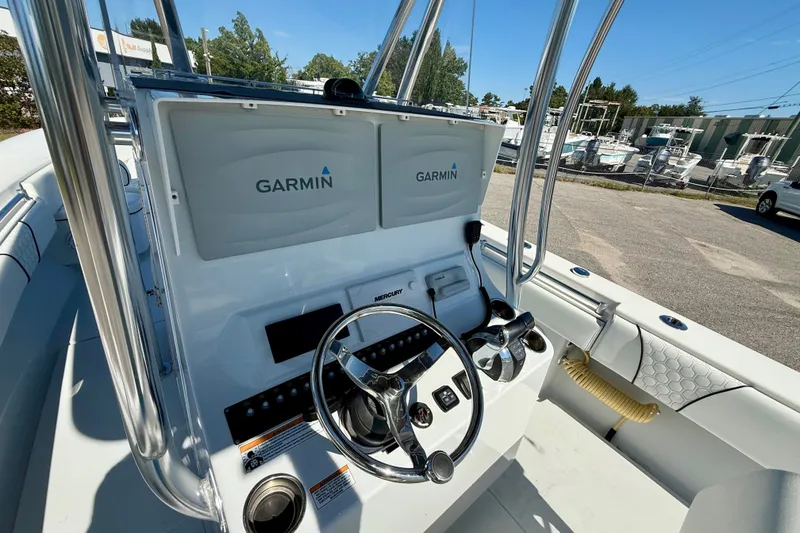 Slide: The Image of 2020 Contender 30 Tournament boat dashboard with Garmin displays and steering wheel. - 13