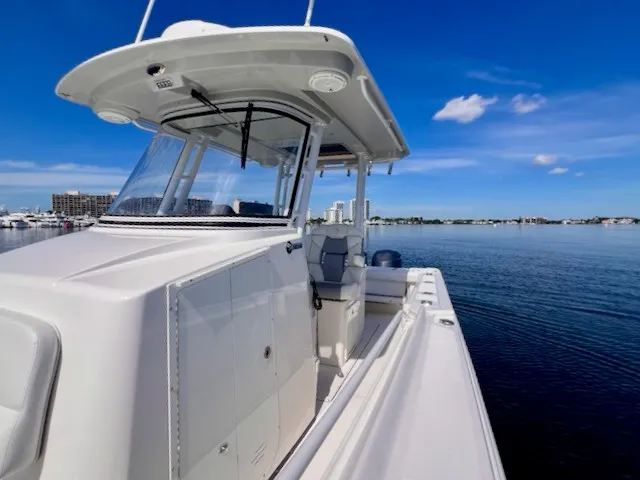 Slide: The Image of 2018 Edgewater 320CC on calm water with clear skies. - 41