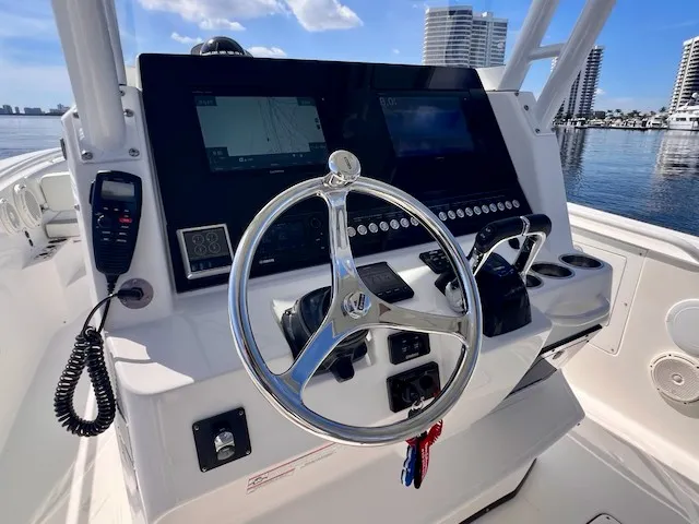 Slide: The Image of Helm of the 2018 Edgewater 320CC with modern navigation system and shiny steering wheel. - 35