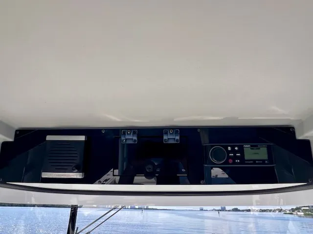 Slide: The Image of The image shows the dashboard of an Edgewater 320CC boat with electronic controls. - 31
