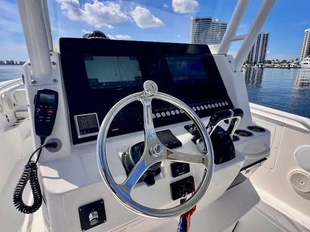 Slide: The Image of The image shows the helm of a 2018 Edgewater 320CC boat with modern navigation equipment. - 36