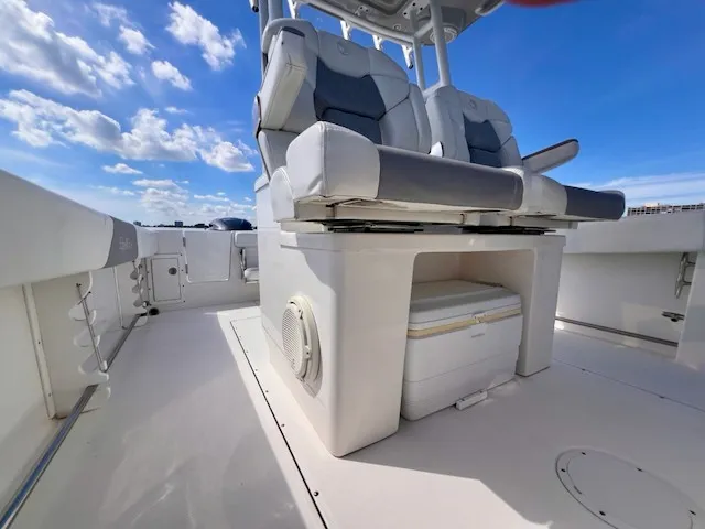 Slide: The Image of The image shows the cockpit of a 2018 Edgewater 320CC boat with cushioned seats. - 45