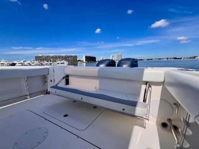 Slide: The Image of The image shows the stern of an Edgewater 320CC boat with a bench seat and two engines. - 21