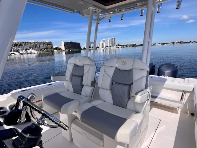 Slide: The Image of Two luxurious seats on an Edgewater 320CC boat, overlooking a calm waterfront scene. - 37
