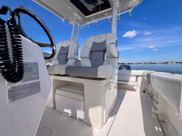 Slide: The Image of The image shows the cockpit of a 2018 Edgewater 320CC boat with luxurious seating. - 39