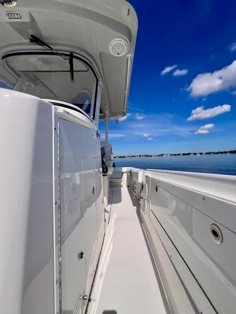 Slide: The Image of An Edgewater 320CC from 2018 on calm water under a blue sky. - 40