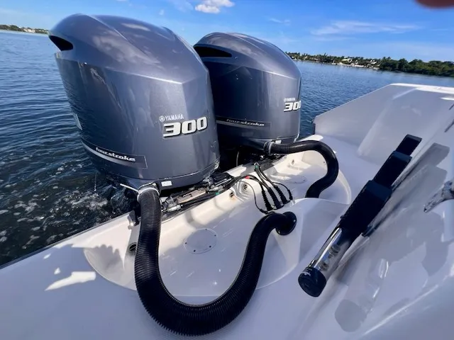 Slide: The Image of Two Yamaha 300 outboard engines on an Edgewater 320CC boat on calm water. - 19