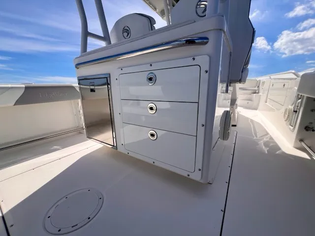 Slide: The Image of The image shows the cockpit of a 2018 Edgewater 320CC with storage and sleek surfaces. - 15