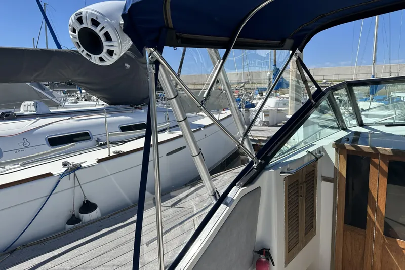 Slide: The Image of 1985 Tiara Yachts 2700 Continental docked, showcasing cockpit and marina surroundings. - 9