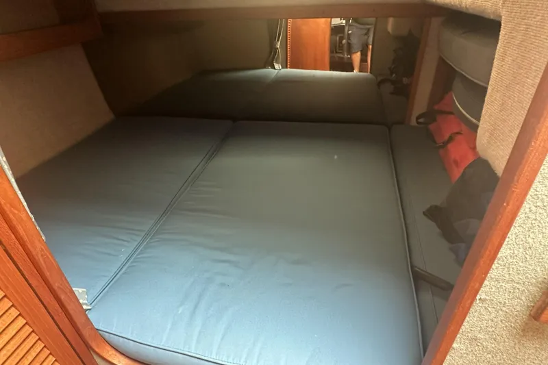 Slide: The Image of Interior cabin of a 1985 Tiara 25 boat with blue cushions. - 17