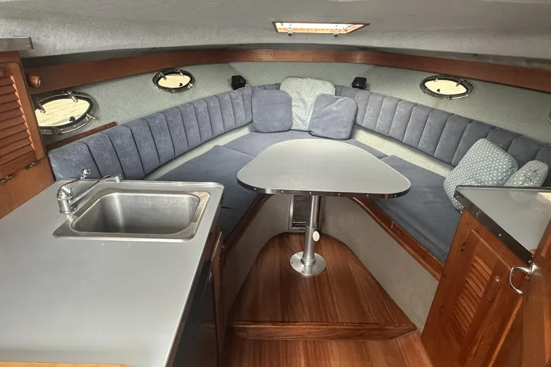 Slide: The Image of Interior of a 1985 Tiara 25 boat with seating, table, and sink. - 12