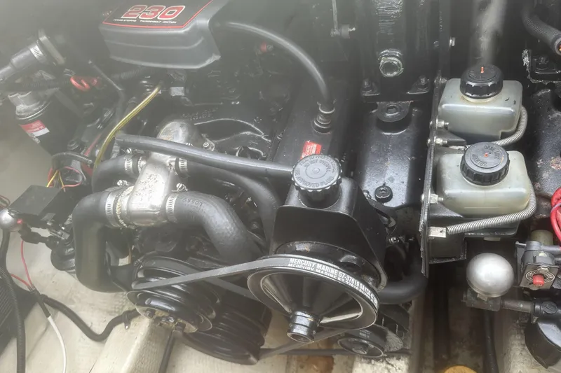Slide: The Image of Engine compartment of a 1985 Tiara 25 boat, featuring a Mercury Marine engine. - 19