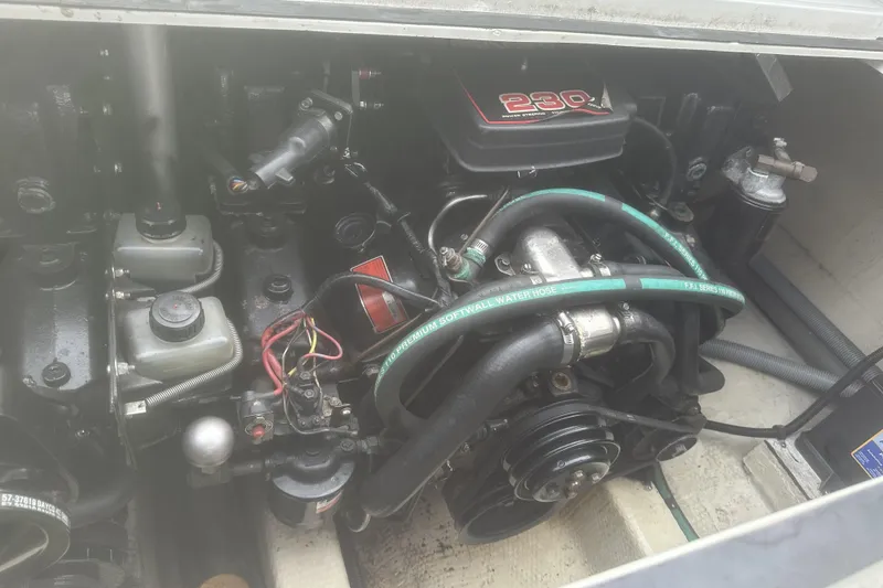 Slide: The Image of Engine compartment of a 1985 Tiara 25 boat, featuring a 230 horsepower motor. - 18