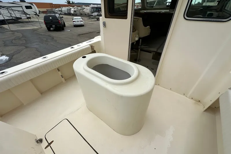 Slide: The Image of 2003 Parker 2520 Deep Vee Sport Cabin boat interior with seating and storage. - 10