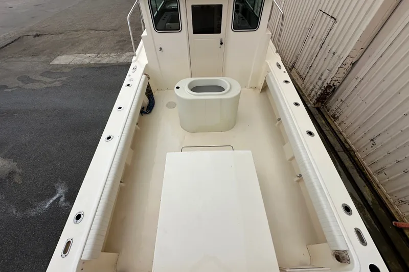 Slide: The Image of 2003 Parker 2520 Deep Vee Sport Cabin boat interior with seating and storage. - 8