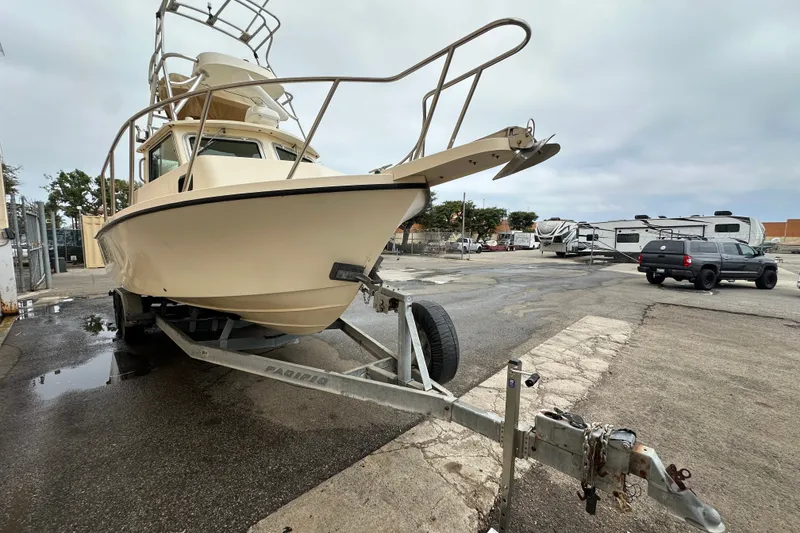 Slide: The Image of 2003 Parker 2520 Deep Vee Sport Cabin boat on trailer in parking lot. - 4