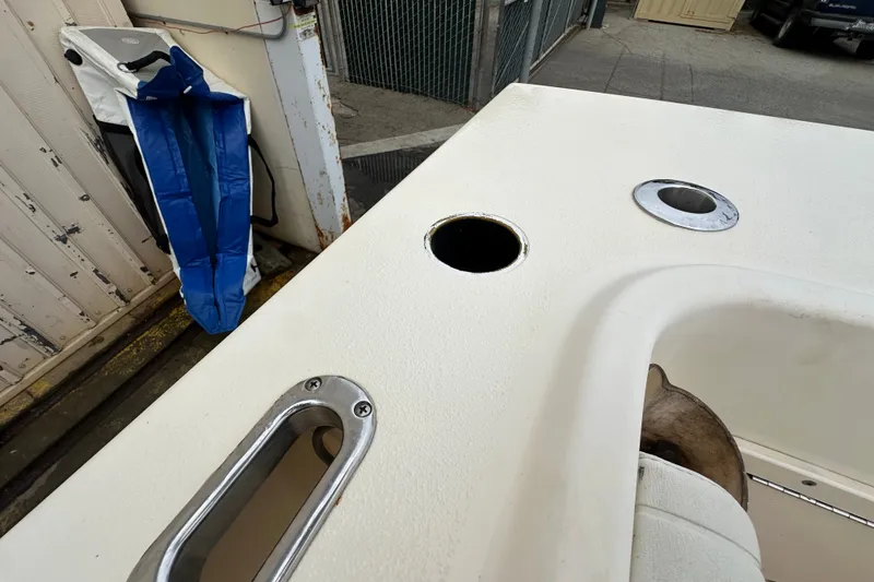 Slide: The Image of 2003 Parker 2520 Deep Vee Sport Cabin boat deck with rod holders and storage. - 27