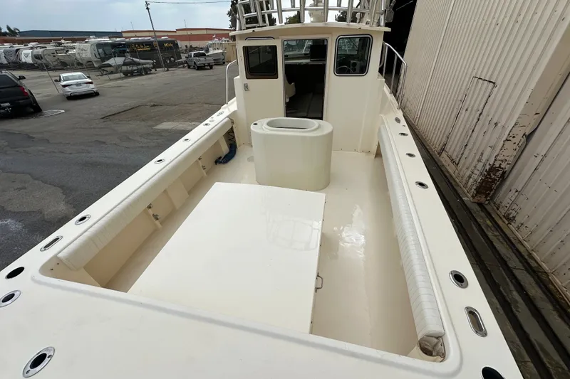 Slide: The Image of 2003 Parker 2520 Deep Vee Sport Cabin boat with spacious deck and cabin view. - 11