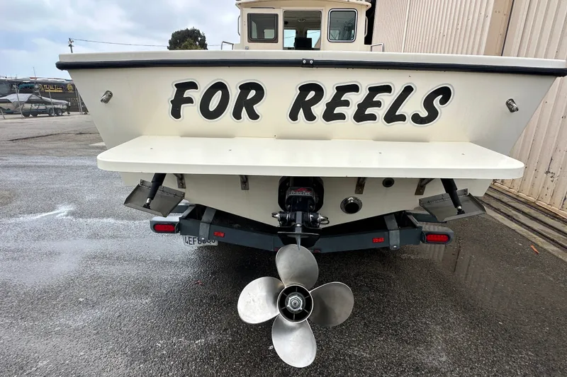 Slide: The Image of 2003 Parker 2520 Deep Vee Sport Cabin boat named "For Reels" on trailer. - 29