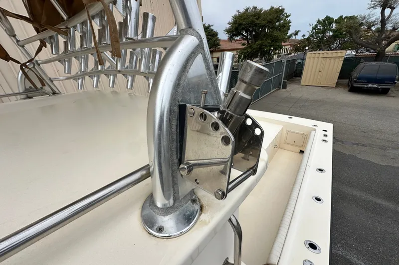 Slide: The Image of 2003 Parker 2520 Deep Vee Sport Cabin boat with rod holders and stainless steel fittings. - 20