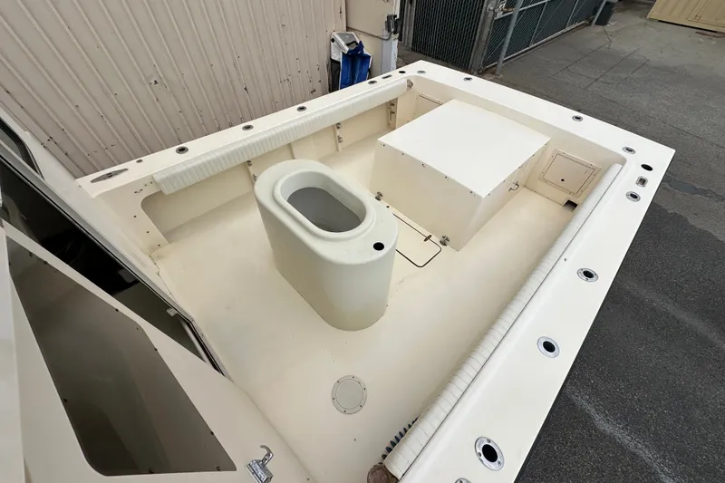 Slide: The Image of 2003 Parker 2520 Deep Vee Sport Cabin boat deck with storage and seating area. - 9