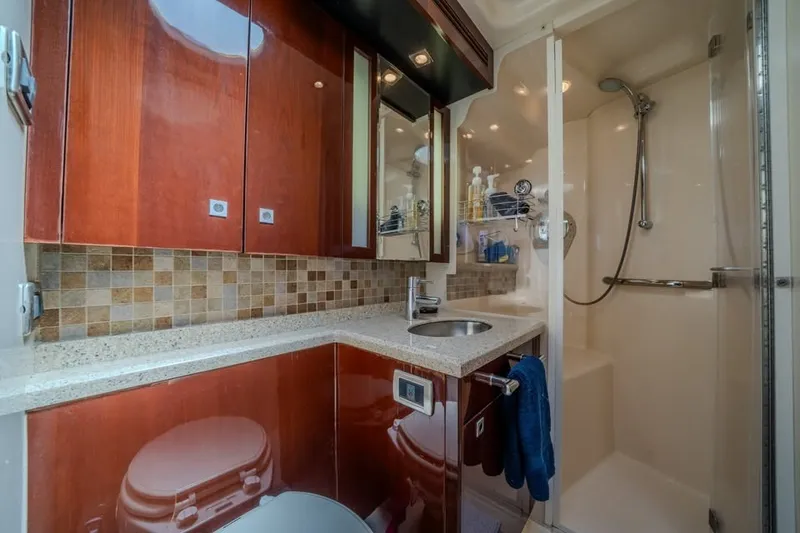 Slide: The Image of Luxurious bathroom in 2008 Sea Ray 47 Sedan Bridge yacht with wood cabinetry and shower. - 13
