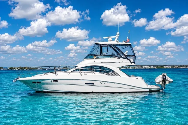 Slide: The Image of 2008 Sea Ray 47 Sedan Bridge yacht on clear blue water under a bright sky. - 1