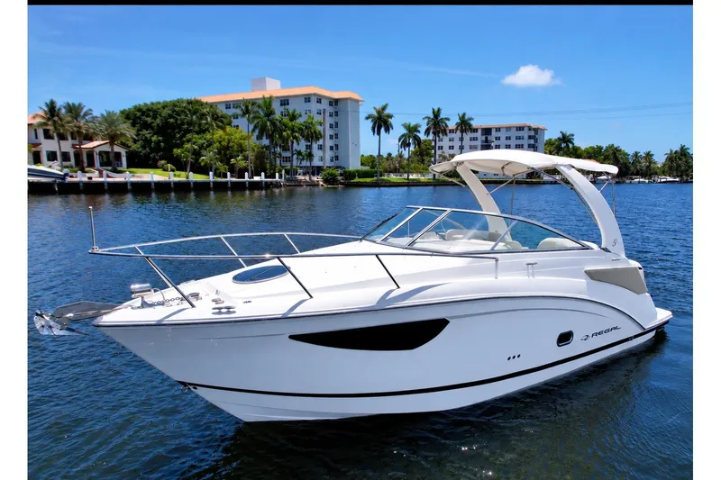 Slide: The Image of 2023 Regal 26 XO boat on calm water with scenic background. - 1