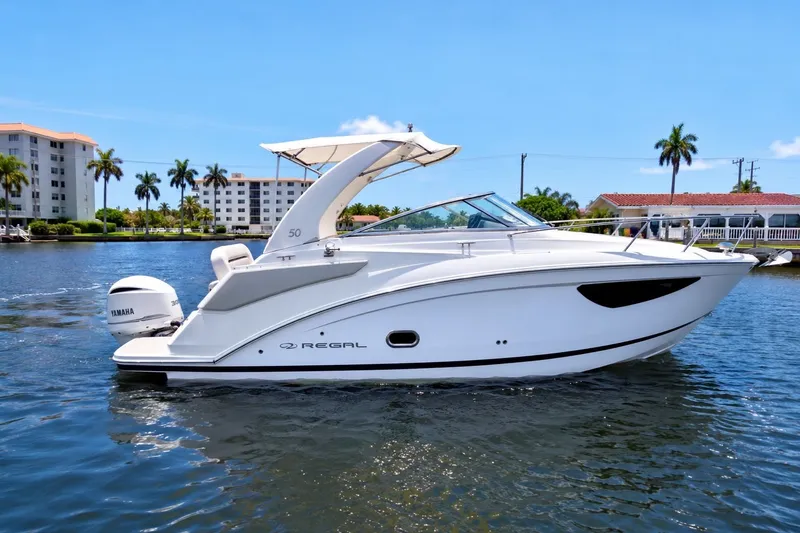 Slide: The Image of 2023 Regal 26 XO boat cruising on a sunny day, featuring sleek design and Yamaha engine. - 0