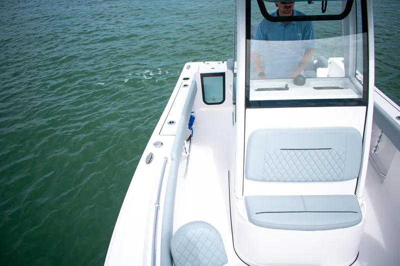 Slide: The Image of 2026 Sportsman Open 212 Center Console boat on water, featuring sleek design and seating. - 13