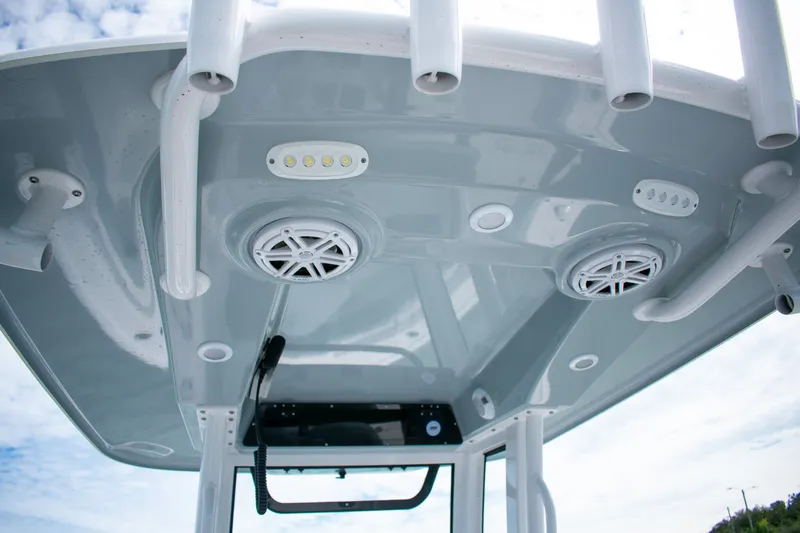 Slide: The Image of 2026 Sportsman Open 212 Center Console boat roof with speakers and rod holders. - 19