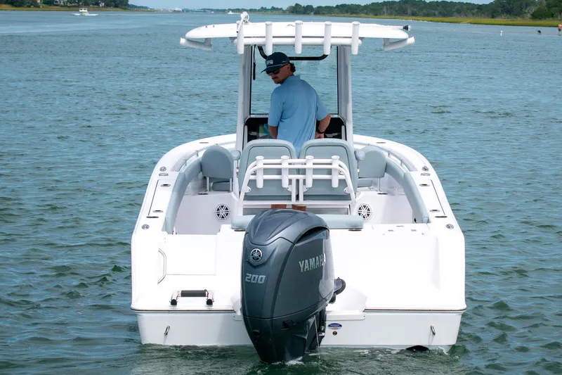 Slide: The Image of 2026 Sportsman Open 212 Center Console boat on water, rear view with Yamaha engine. - 7