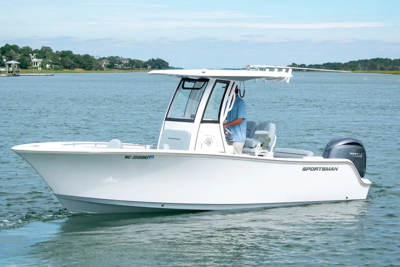 Slide: The Image of 2026 Sportsman Open 212 Center Console boat cruising on a calm lake. - 3